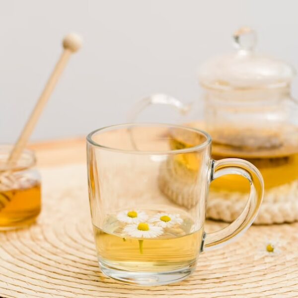 high-angle-glass-with-teapot-honey-jar_23-2148567526