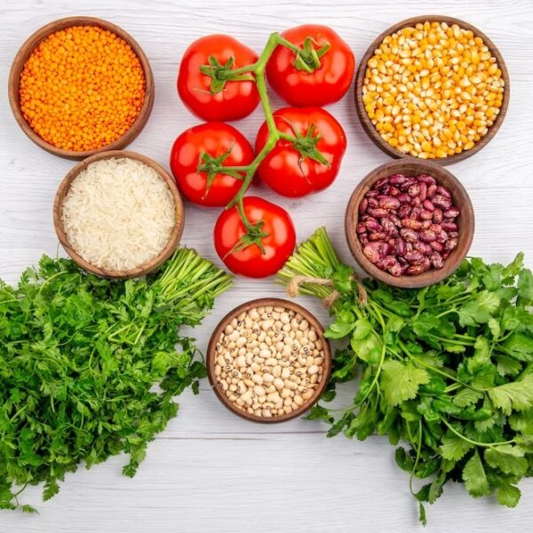 top-view-fresh-tomatoes-with-stem-corn-yellow-lentils-bundle-greens-pepper-long-rice-white-table_140